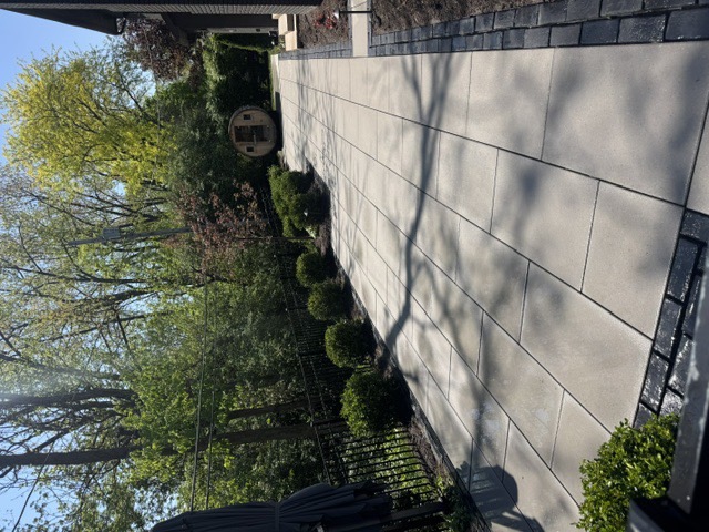 After: the same stone-slab walkway deep-cleaned and sealed, with the staining lifted