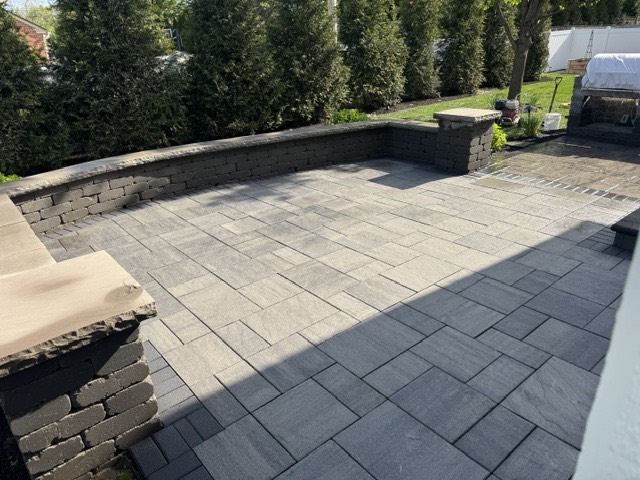 After: the same bluestone patio cleaned and sealed to a rich, wet-look finish