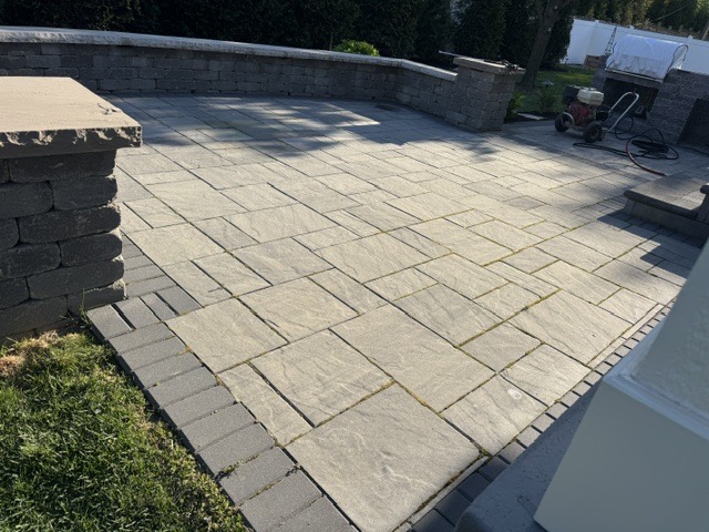 Before: a bluestone patio looking dull and gray with moss in the joints